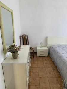 a bedroom with a bed and a dresser with a mirror at HouseMi in Magliano di Tenna +22 photos