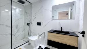 a white bathroom with a sink and a shower at Apartamento Lujoso Centro Torrevieja in Torrevieja +16 photos