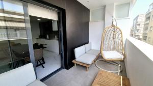 a room with a chair and a window at Apartamento Lujoso Centro Torrevieja in Torrevieja