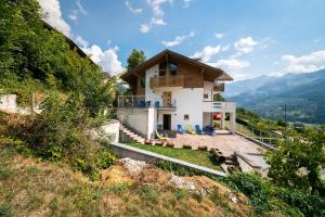 a house on the side of a hill at B&B Casa Nadia in Tesero