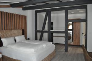 a bedroom with a bed and a large window at Spreehotel Spremberg in Spremberg +10 photos