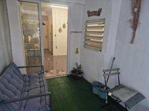 a room with a bed and a chair in a room at romarin 3 in Saint-Denis