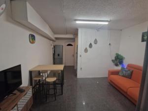 a living room with a couch and a table at romarin 3 in Saint-Denis