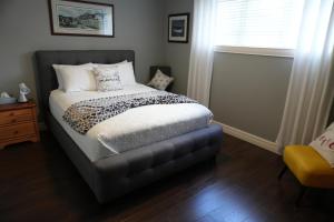 a bedroom with a bed and a window at The Blue Jay Nest in Topsail