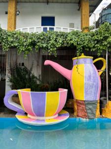 two vases and a tea pot on top of a pool at Isla Paraiso Resort-Hotel in Sison