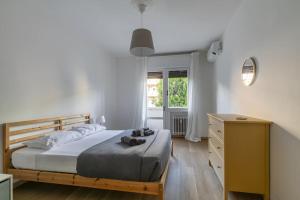 a bedroom with a bed and a dresser and a window at i-HOMES Family Comfort Padova in Padova