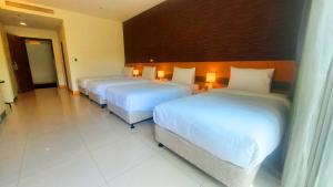 Postel nebo postele na pokoji v ubytování Zu San HOTEL