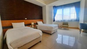 Postel nebo postele na pokoji v ubytování Zu San HOTEL