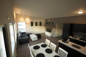 a living room with a couch and a table and a kitchen at Ersfjordbotn Brygge in Ersfjordbotn