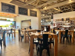 a dining room with wooden tables and chairs in a restaurant at At last in Pearly Beach