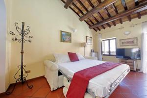 a bedroom with a bed and a television in it at Classic roman home next to Popolo Square in Rome