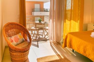 a room with a bed and a chair and a table at Sunny Condo-Pool by Algarve Dream Holidays in Albufeira