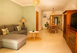 a living room with a couch and a table at Sunny Condo-Pool by Algarve Dream Holidays in Albufeira
