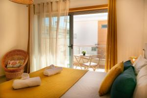 a bedroom with a bed with two towels on it at Sunny Condo-Pool by Algarve Dream Holidays in Albufeira +23 photos