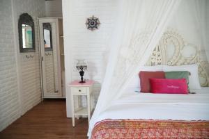 a bedroom with a white bed with a canopy at Berawagaya Bungalows in Dalung +53 photos
