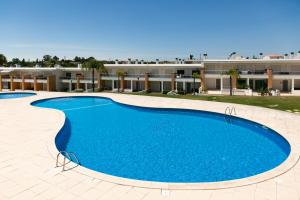 a large swimming pool in front of a building at Sunny Condo-Pool by Algarve Dream Holidays in Albufeira