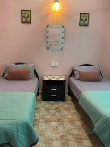 Postel nebo postele na pokoji v ubytování Seri Idaman Guest House (Pasir Mas)