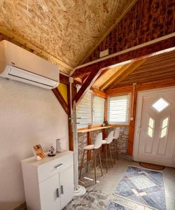a kitchen with a refrigerator and chairs in a room at Apartman Visoko-Oaza mira in Visoko +30 photos