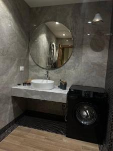 a bathroom with a sink and a washing machine at Sea Breez The Grant Hotel Apartment in Bilgah +13 photos