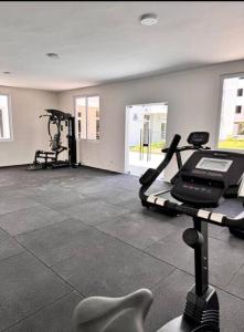 a gym with two exercise bikes and a treadmill at Azure 3bdrm beachfront at jumeirah palm resort nyali in Bamburi +17 photos