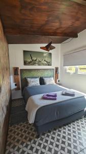 a bedroom with a large bed and a ceiling at CASA FARO ARTE in Potrerillos