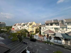 a row of houses in a city with a parking lot at Karpal Singh Drive Seaside Georgetown 4BR-15pax by 3C in George Town