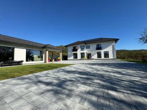 a house with a large driveway in front of it at Vila Diamond Lux&Spa in Sovata
