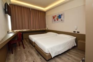 Postel nebo postele na pokoji v ubytování The Gate Hotel - Firenze Nord