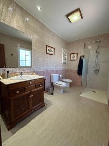 a bathroom with a sink and a shower and a toilet at Casa Tortuga in Tarajalejo +35 photos
