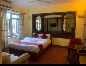 a bedroom with a bed and a large mirror at Buddha Home Nepal in Thapathali