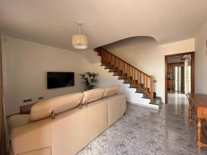 a living room with a couch and a tv at Casa Tortuga in Tarajalejo