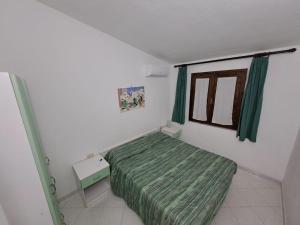 a small bedroom with a bed and a window at Villa cesar in Costa Paradiso +15 photos