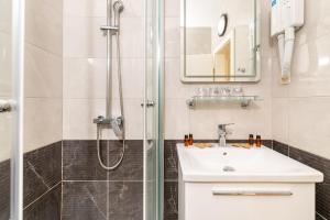 a bathroom with a sink and a shower at Hotel Timun in Gdinj +37 photos