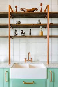 a kitchen counter with a sink and some shelves at Villa Chateau Artwine in Art'ana