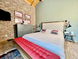 a bedroom with a large bed with a red blanket at Villa Chateau Artwine in Art'ana +31 photos