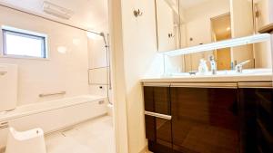 a bathroom with a sink and a tub and a toilet at DeL'm 難波から徒歩圏内京都奈良universal studio 関西空港まで交通便利無料駐車場付き in Osaka +51 photos