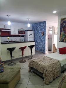 a living room with a bed and a kitchen at Apartamento no centro de São Paulo in Sao Paulo