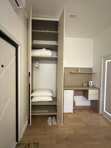 a room with a closet with shelves and a bed at Apartment suite Mukachevo in Mukacheve