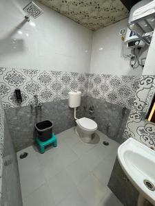 a bathroom with a toilet and a sink at HOTEL KAVANA in Varanasi +53 photos