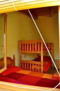 a bedroom with two bunk beds in a room at Cal Tresonito in Coll de Nargó