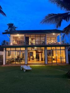 a large house with a lot of windows at Villa Leela Bentota in Induruwa