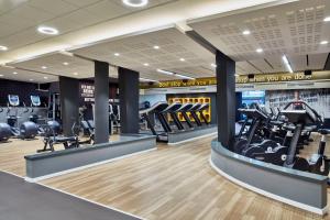 a gym with treadmills and elliptical machines at Kfar Maccabiah Business & Sport Hotel in Ramat Gan