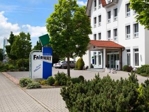 a sign for a hotel in front of a building at Fairway Hotel in Sankt Leon-Rot +44 photos