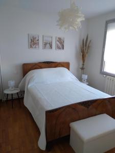 a bedroom with a large bed with a white bedspread at villa au calme 6 couchages in Trèbes