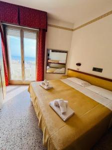 Postel nebo postele na pokoji v ubytování Hotel Columbia Frontemare