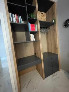 a book shelf in a room with books at Anais apartment in Preveza