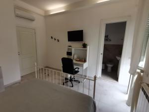 a bedroom with a bed and a desk and a chair at GioCla in Cassino