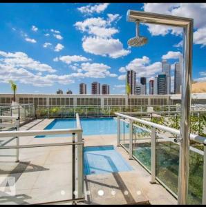 a swimming pool with a view of a city at Apartamento dentro do shopping águas claras, Lindo in Taguatinga