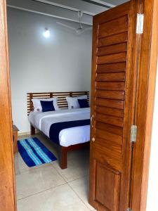 une chambre avec un lit et une porte en bois dans l'établissement Luna Park & Resort, à Kottakupam