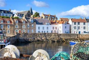 a view of a town with a river and buildings at No3 By The Sea a 5 Star Cozy Coastal Cottage in Saint Monance